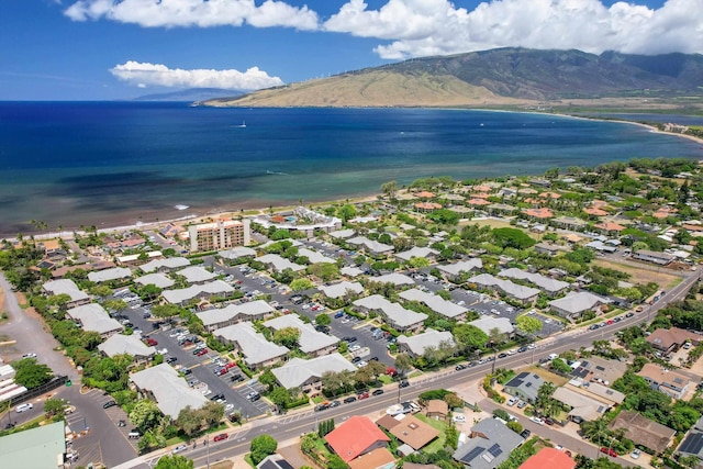 birds eye view of property with a water and mountain view