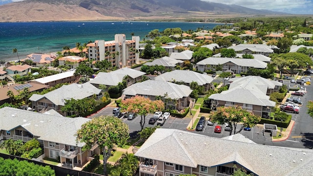 birds eye view of property with a water and mountain view