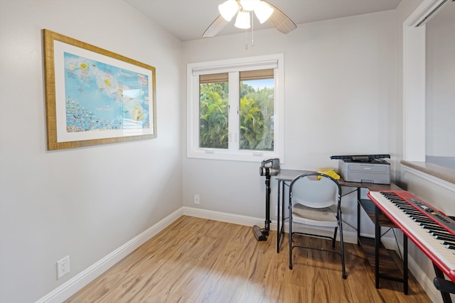 misc room with light hardwood / wood-style floors and ceiling fan