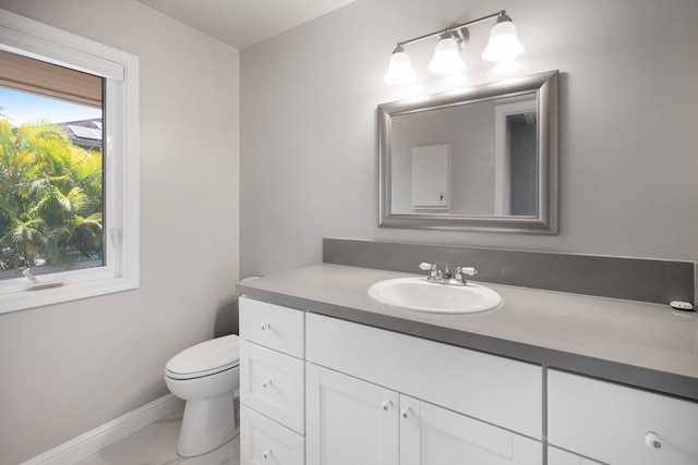 bathroom with vanity, toilet, and tile patterned flooring