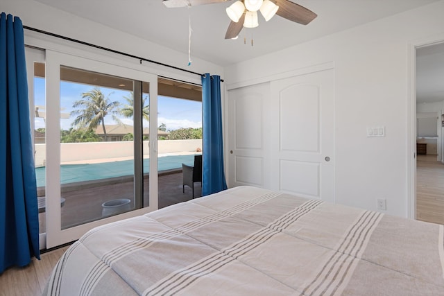 bedroom featuring a closet, light hardwood / wood-style floors, access to outside, and ceiling fan