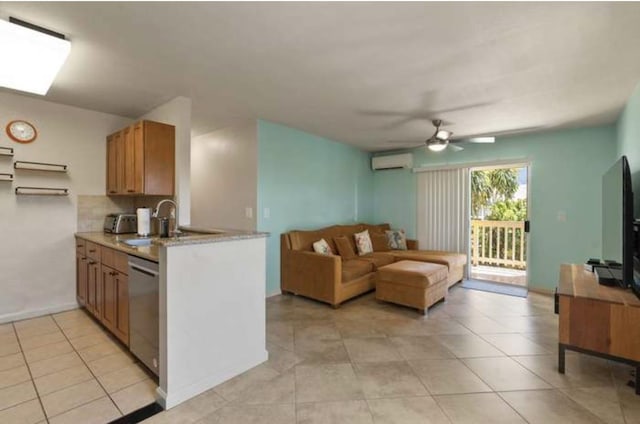 kitchen with ceiling fan, dishwasher, light tile patterned floors, and an AC wall unit