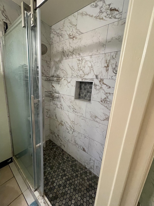 bathroom featuring a shower with door