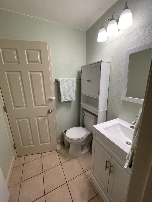 bathroom featuring vanity, tile patterned floors, and toilet