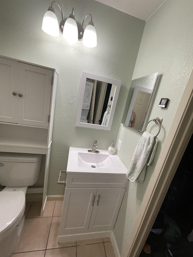 bathroom featuring tile patterned flooring, vanity, and toilet