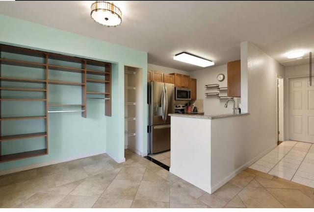 kitchen with appliances with stainless steel finishes and light tile patterned floors