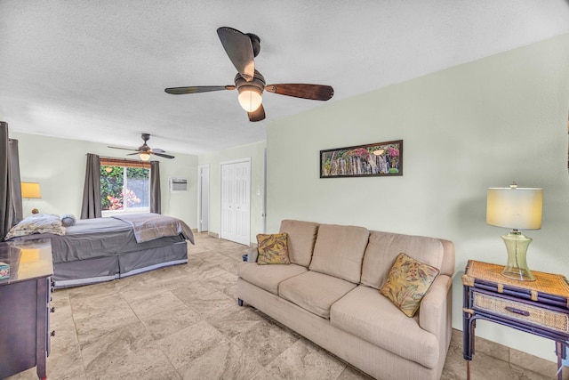 bedroom with a textured ceiling and ceiling fan