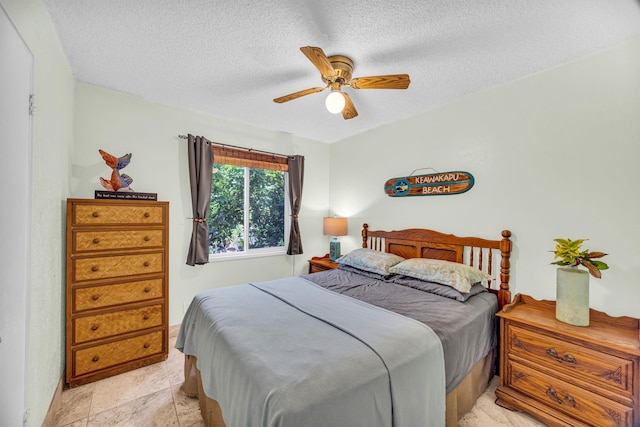 bedroom featuring a ceiling fan and a textured ceiling
