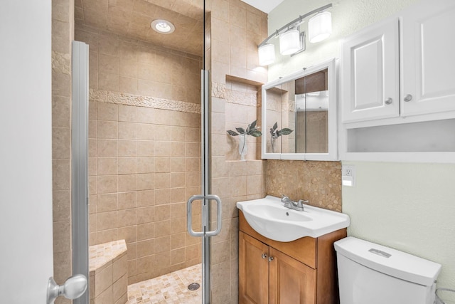 full bath featuring a shower stall, toilet, and vanity
