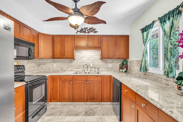 kitchen featuring brown cabinetry, black appliances, backsplash, and a sink