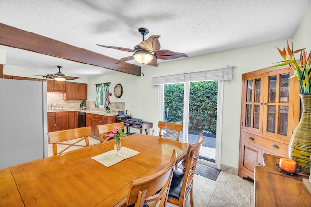 dining space with light tile patterned floors, a ceiling fan, a textured ceiling, and beamed ceiling
