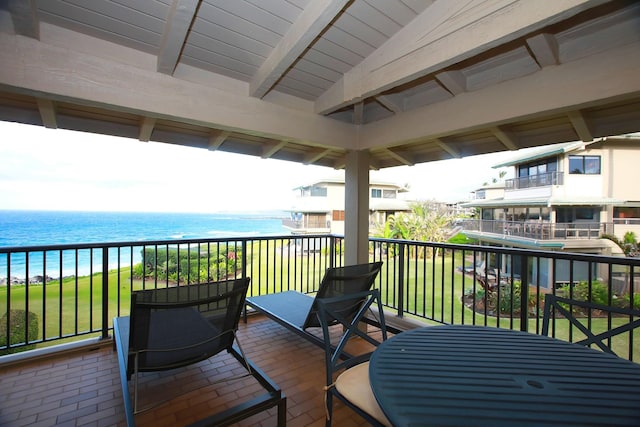 wooden terrace featuring a water view and a yard