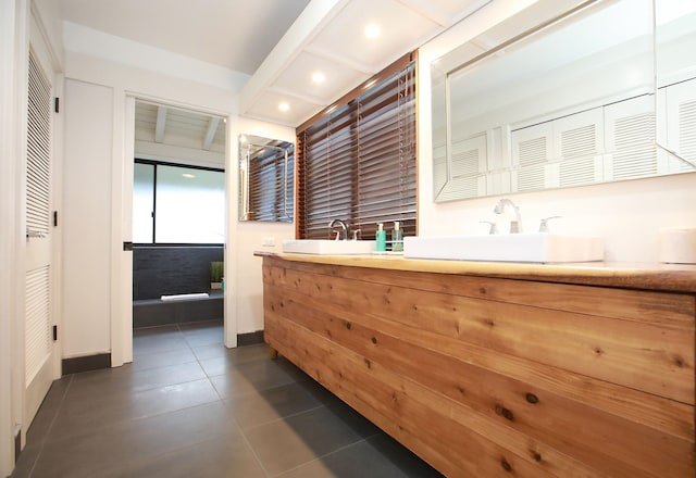 bathroom featuring tile flooring and vanity