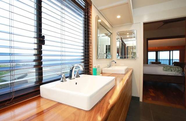 bathroom with dual bowl vanity and tile floors