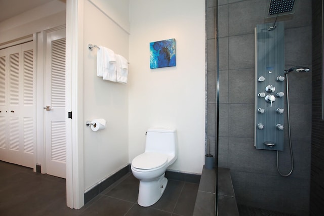 bathroom with toilet and tile floors