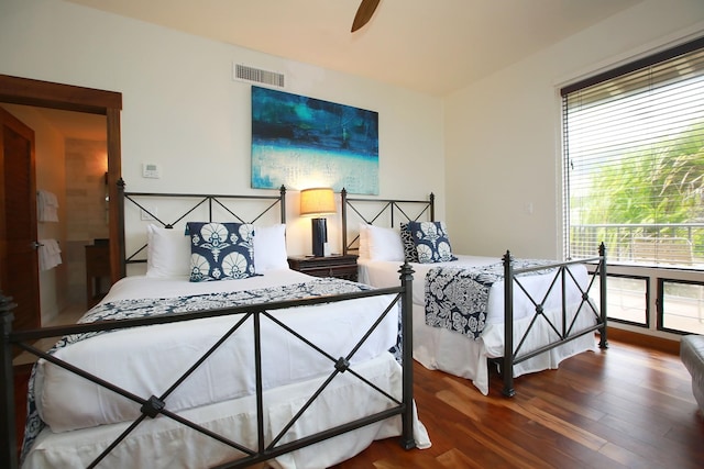 bedroom with ceiling fan and dark hardwood / wood-style flooring