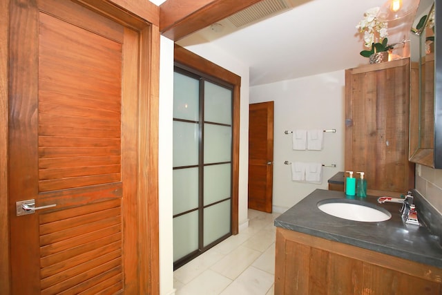 bathroom featuring tile flooring and large vanity