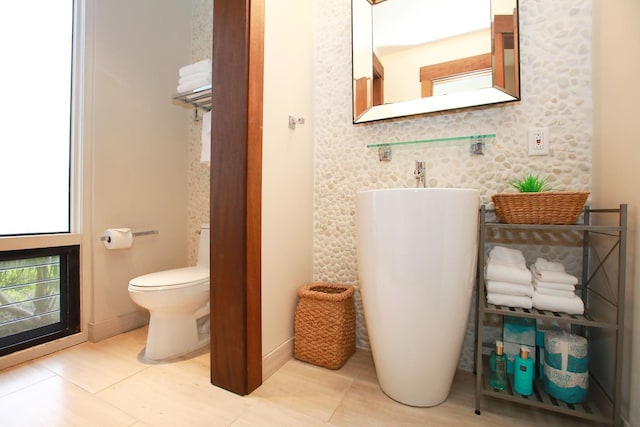 bathroom with tile floors and toilet