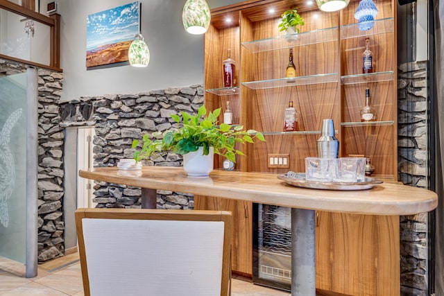 bar with light tile patterned floors and wood counters