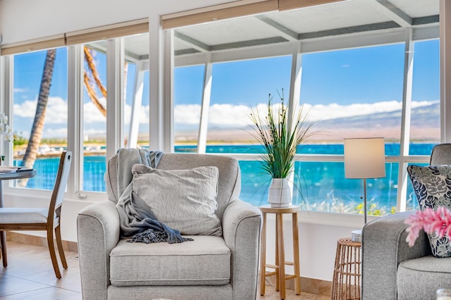 sunroom with a water view and a wealth of natural light