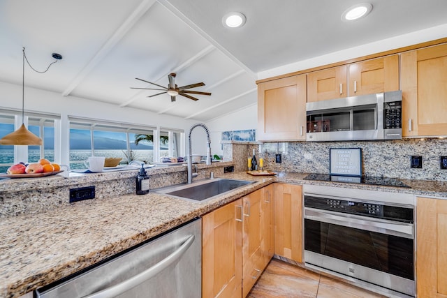 kitchen featuring stainless steel appliances, sink, vaulted ceiling with beams, and backsplash