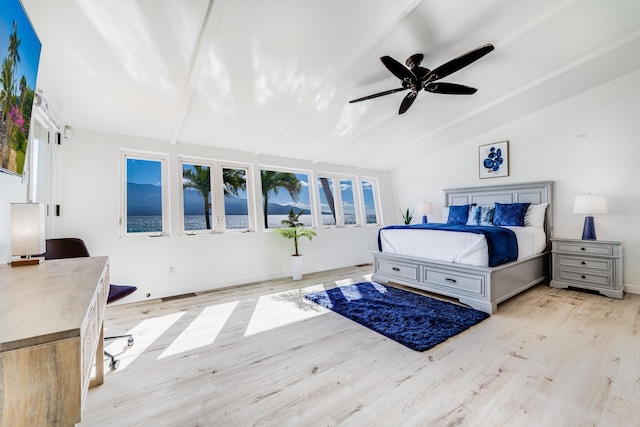 bedroom featuring vaulted ceiling with beams, light hardwood / wood-style floors, and ceiling fan