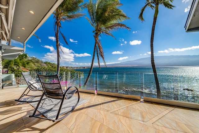 exterior space featuring a balcony and a water and mountain view