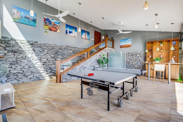 playroom featuring ceiling fan and a high ceiling