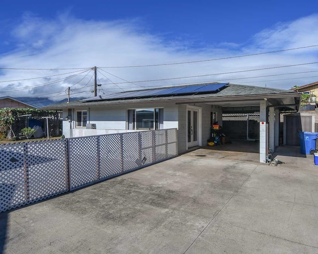 exterior space featuring a patio area, french doors, and solar panels