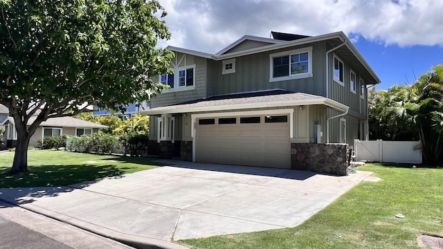 view of front of property featuring an attached garage, board and batten siding, fence, stone siding, and a front lawn