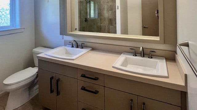 bathroom featuring walk in shower, vanity, and toilet