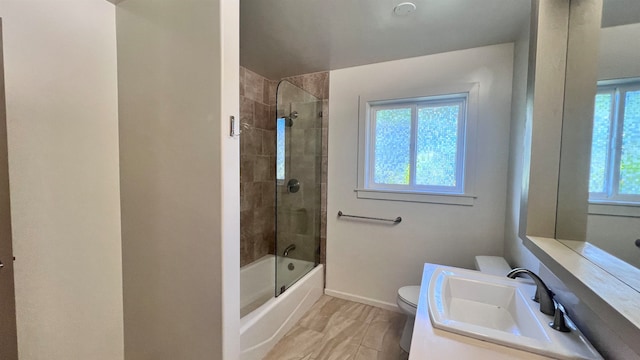 full bathroom featuring tiled shower / bath, toilet, and vanity