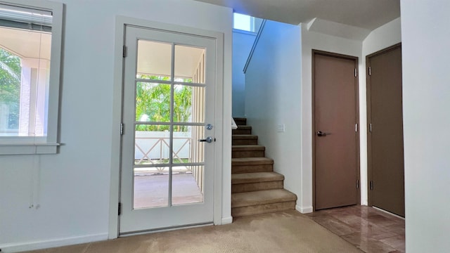 doorway featuring light colored carpet