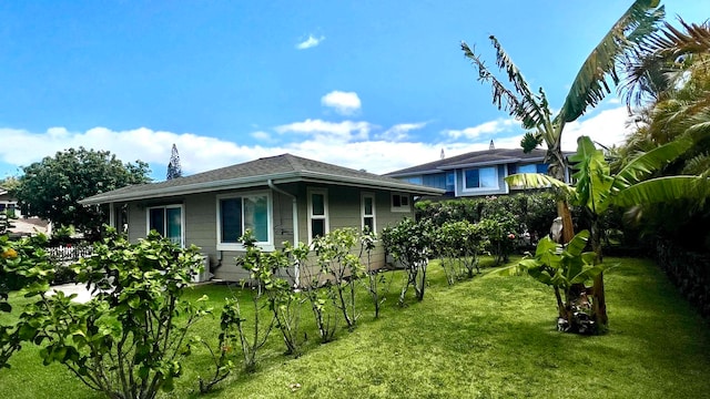 view of side of home featuring a lawn