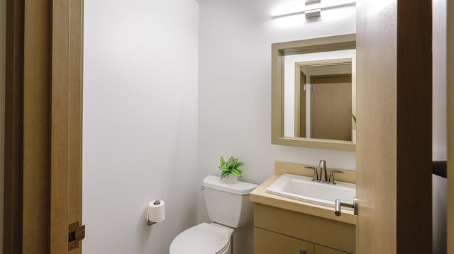 bathroom featuring toilet and vanity