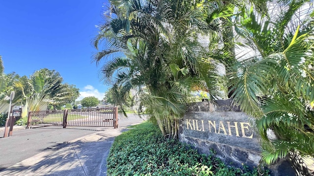 community / neighborhood sign featuring a gate