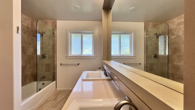 full bathroom with bathing tub / shower combination, baseboards, wood finished floors, and vanity