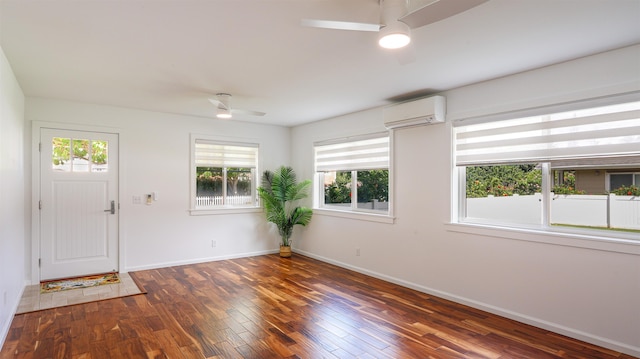foyer entrance featuring baseboards, a ceiling fan, wood finished floors, and a wall mounted air conditioner