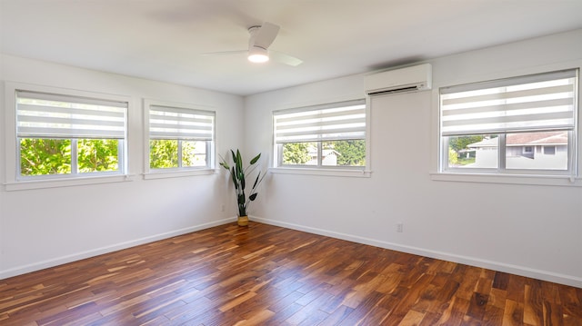 empty room with baseboards, an AC wall unit, a ceiling fan, and wood finished floors