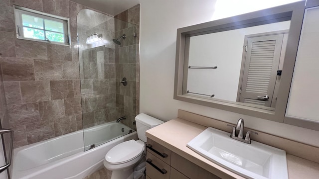 bathroom featuring shower / bathing tub combination, vanity, and toilet