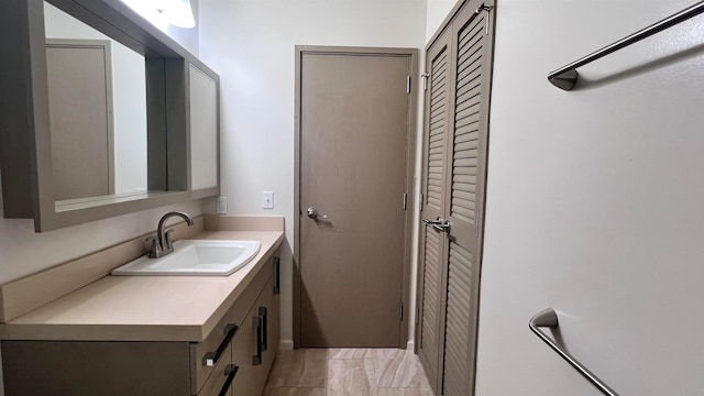 bathroom featuring a closet and vanity