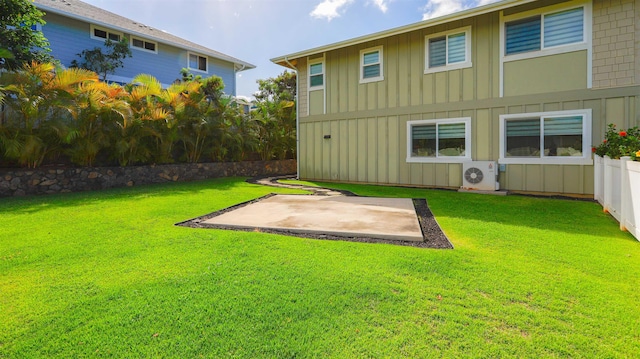 back of house with ac unit, board and batten siding, a patio area, and a lawn