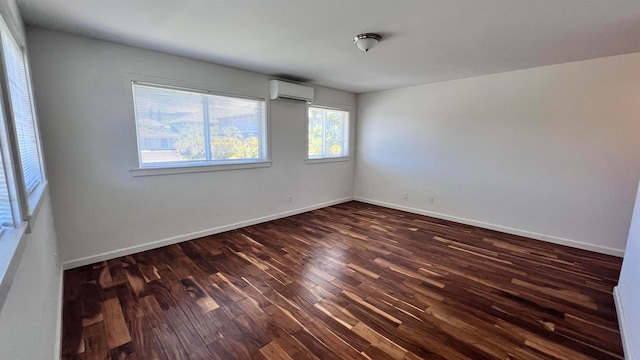 empty room with dark hardwood / wood-style flooring and a wall mounted AC