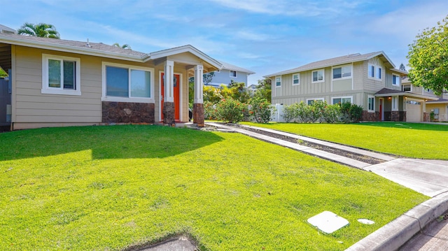 view of front facade with a front lawn and stone siding