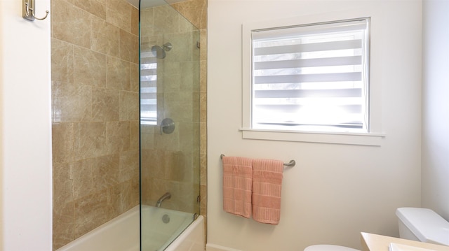 full bathroom featuring toilet, shower / bath combination with glass door, and vanity