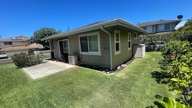 rear view of property featuring a lawn