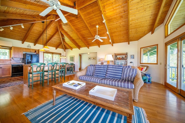 living room with high vaulted ceiling, dark wood-type flooring, beamed ceiling, and wooden ceiling