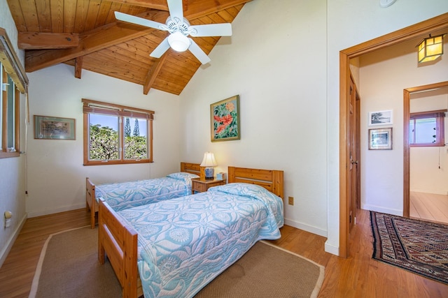 bedroom with ceiling fan, wood ceiling, light hardwood / wood-style flooring, and lofted ceiling with beams