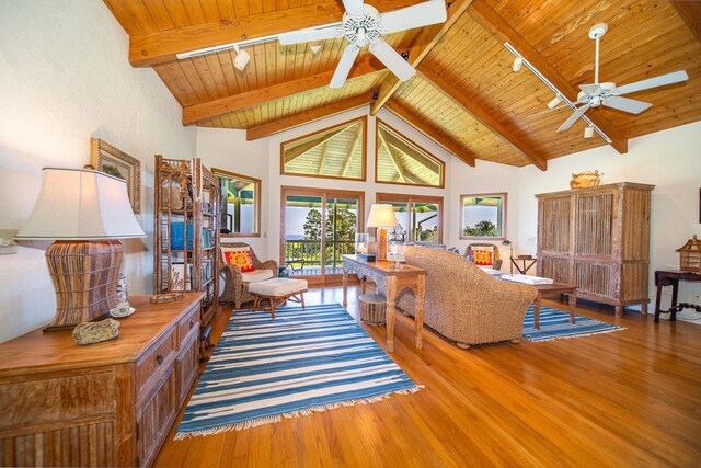 living room with beamed ceiling, hardwood / wood-style flooring, and wooden ceiling