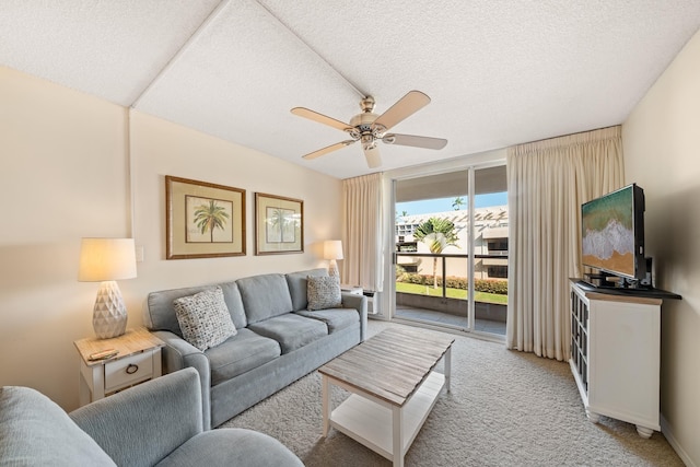 living room with ceiling fan, light carpet, and a textured ceiling